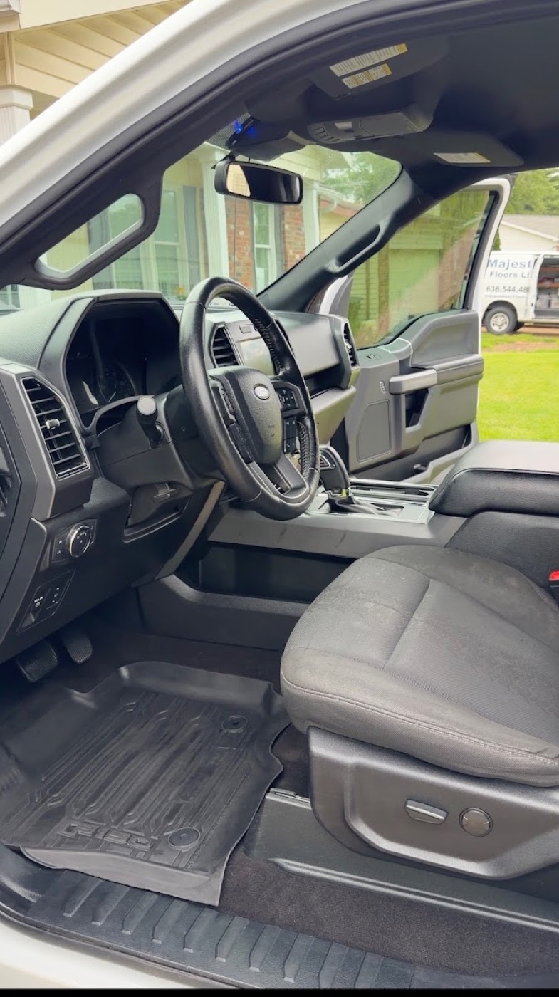 Spotless truck interior with clean floor mats and dashboard after a detail