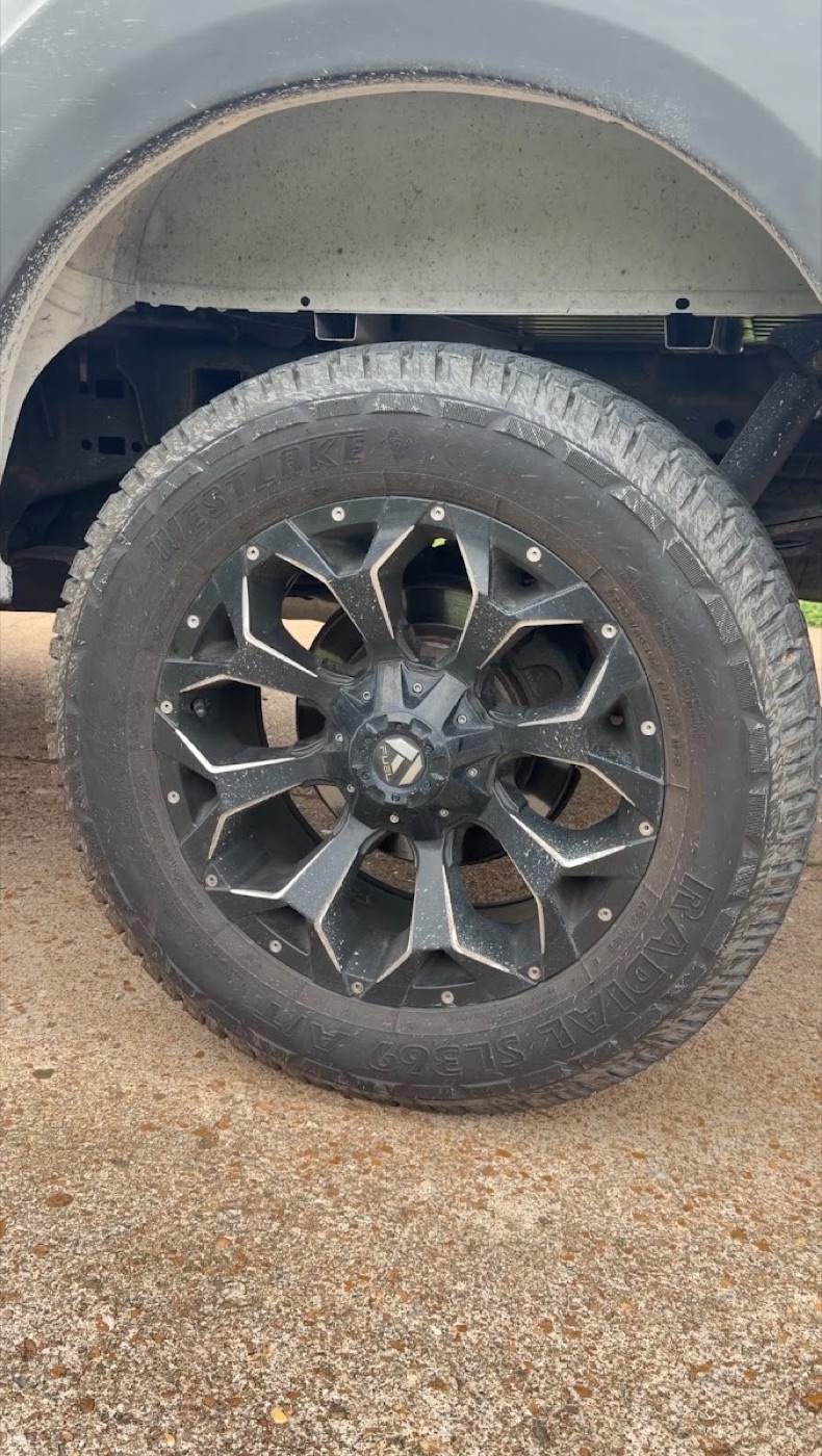 Dusty truck wheel and fender before detailing